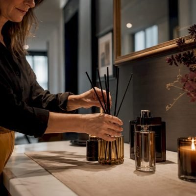 Woman arranging luxury home scenting products