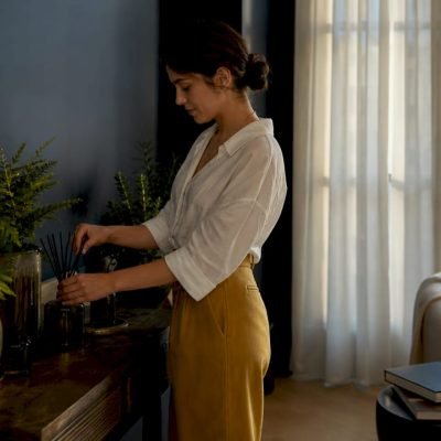 Woman setting natural home fragrance diffuser